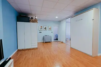 a large room with blue walls and a wooden floor at Fun Apt, City of Arts, ChillOut Zone, Soccer Table in Valencia