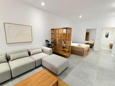 a living room with a couch and a bed at Travel Habitat Jesus-Patraix Familiar Apartment in Valencia