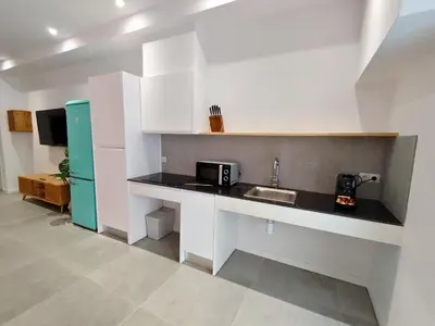 a kitchen with a sink and a refrigerator at Travel Habitat Jesus-Patraix Familiar Apartment in Valencia