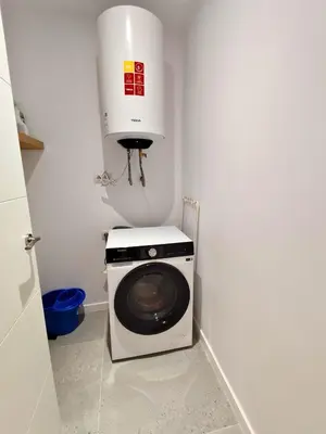 a kitchen with a washing machine and a white appliance at Travel Habitat Jesus-Patraix Familiar Apartment in Valencia