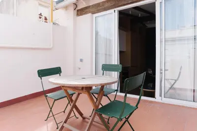 a wooden table and four chairs in a room at Burriana X - Estudio in Valencia