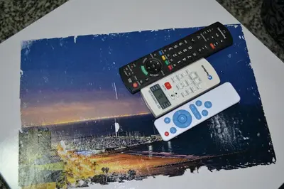 two remote controls sitting on top of a book at Pobla de Farnals BEACH APARTMENT in Puebla de Farnals