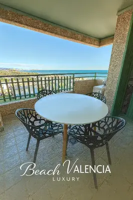 a table and chairs on a balcony with the ocean at BEACH VALENCIA LUXURY D7-21 Apartment with terrace and sea views with two rooms in Valencia
