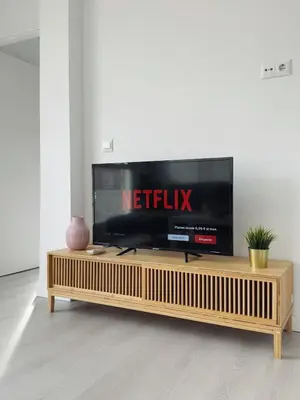 a flat screen tv sitting on top of a wooden entertainment center at Apartment Ruzafa Market 9B in Valencia