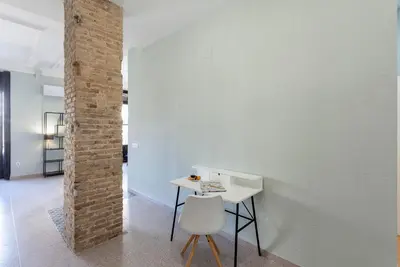 a white table and chair in a room with a brick wall at Apartment 2 bedroom Historical Center in Valencia