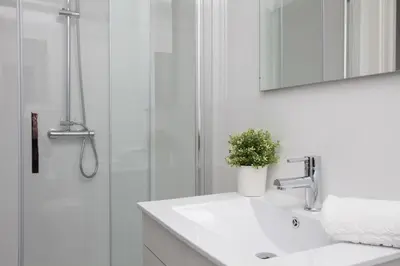 a white bathroom with a sink and a shower at Quart Apartment in Valencia