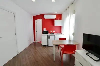 a kitchen with a table with two chairs and a television at Tu Estudio En El Centro-Ruzafa 10A in Valencia
