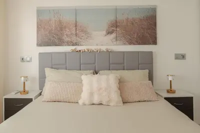 a bedroom with a large white bed with two lamps at Top Floor 2 Bedroom Apartment with Terrace in Valencia