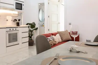 a kitchen and living room with a table and a couch at Top Floor 2 Bedroom Apartment with Terrace in Valencia