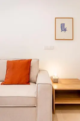 a living room with a couch and a wooden table at B - Design apartment at El Grao close to the beach in Valencia