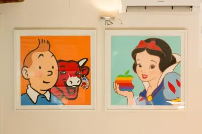 two paintings of a man and a woman on a wall at Ático Exclusivo del Siglo XVI con Dos Terrazas en el Corazón de Ciutat Vella in Valencia