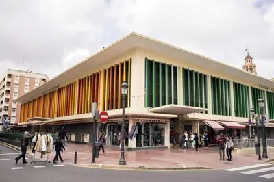 a large building with people walking in front of it at Ático Exclusivo del Siglo XVI con Dos Terrazas en el Corazón de Ciutat Vella in Valencia