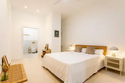 a white bedroom with a large white bed with two lamps at C - Design apartment El Grao close to the beach in Valencia