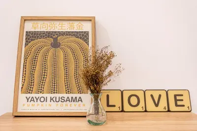 a vase on a table with a picture of a pumpkin at C - Design apartment El Grao close to the beach in Valencia
