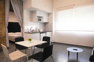 a small kitchen and dining room with a table and chairs at Soho Valencia in Valencia