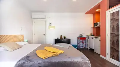 a bedroom with a bed with a yellow towel on it at Tu Estudio En El Centro-Ruzafa 10C in Valencia