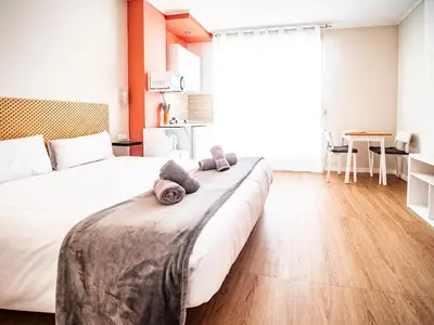 a bedroom with a large bed with two pillows on it at Estudio En El Centro-Ruzafa 10D in Valencia