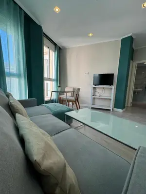 a living room with a couch and a glass table at Tu Apartamento En El Centro - Ruzafa 8D in Valencia