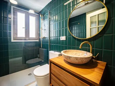 a bathroom with a sink and a mirror and a toilet at Tu Penthouse En El Centro - Ruzafa 11C in Valencia