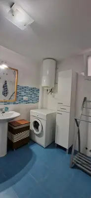 a bathroom with a washing machine and a sink at Mar y montaña in Nules