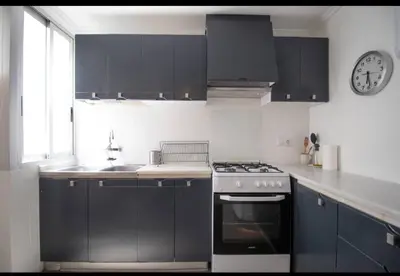 a kitchen with a stove and a clock on the wall at Casa vistas al rio in Navajas