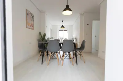 a dining room with a table and chairs at Encantador Apartamento de Lujo en Valencia 3 Dormitorios in Paterna