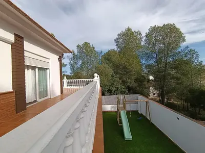a balcony with a slide and a playground at El otro cielo Playamonte in Navarrés