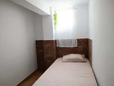 a small room with a bed and a window at El otro cielo Playamonte in Navarrés
