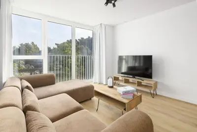 a living room with a couch and a flat screen tv at ApartUP Port Marina Azura in Valencia