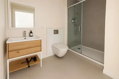 a bathroom with a toilet sink and a shower at Roca Collection MSuites in Valencia
