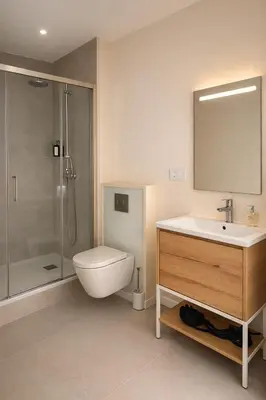 a bathroom with a sink and a toilet and a shower at Roca Collection MSuites in Valencia