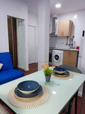 a kitchen with a table with two blue plates on it at Benimaclet JTM in Valencia