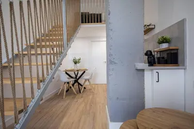 a room with a table and a staircase with a table at Estudio con Altillo en Malilla cerca de La Fe in Valencia