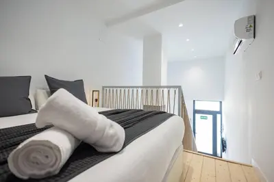 a bedroom with a bed with towels on it at Estudio con Altillo en Malilla cerca de La Fe in Valencia