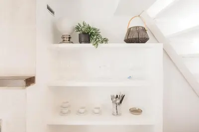 a bathroom with white shelves and a sink at Brisas Chulilla Loft with Terrace in Chulilla