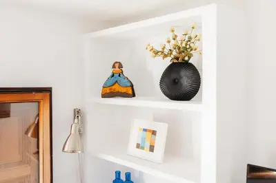 a room with white shelves and a vase with flowers at Brisas Chulilla Loft with Terrace in Chulilla
