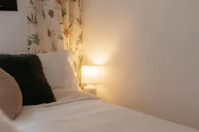 a bedroom with a bed with a lamp next to it at Brisas Chulilla Boutique Apartment in Chulilla