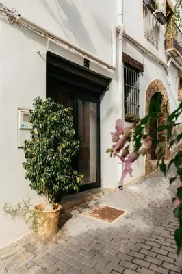a door to a building with a tree in front of it at Brisas Chulilla Mirador House in Chulilla