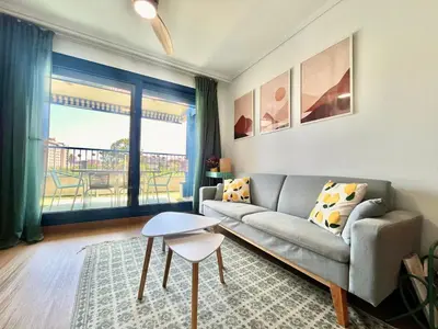 a living room with a couch and a table at Beachfront Family Apt in Valencia