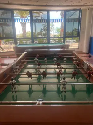 a group of people playing a game on a pool table at Beachfront Family Apt in Valencia