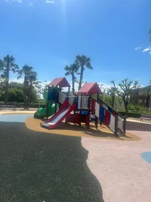 a playground with a slide in a park at Beachfront Family Apt in Valencia