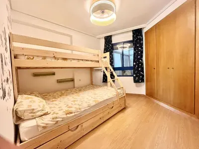 a bedroom with two bunk beds in it at Beachfront Family Apt in Valencia