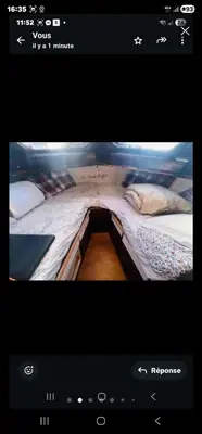 a bed in a room with a tv screen with a bed sidx sidx at La Pepa in Valencia