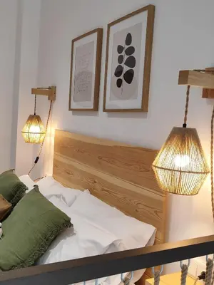 a bedroom with two lamps on the wall and a bed at Loft acogedor junto al Roig Arena in Valencia