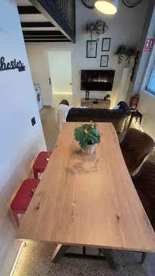 a wooden table in a living room with a plant on it at Impresionante Apartamento Industrial wifi gratis hasta 4 os encantará in Valencia