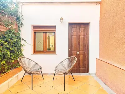 two chairs sitting in front of a door at Charming brand-new loft with garden and pool in Pla del Pou