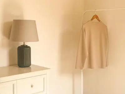 a lamp and a dress hanging on a wall at Charming brand-new loft with garden and pool in Pla del Pou