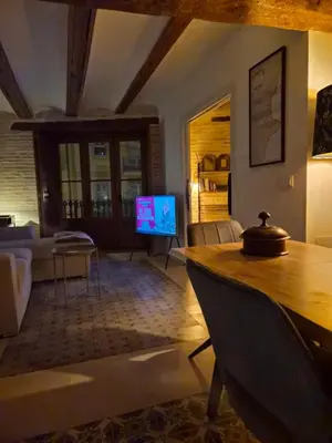 a living room with a table and a tv at Valencia Catedral Apt in Valencia