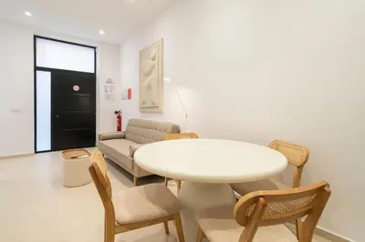 a living room with a white table and chairs at VLC Host - Cubells 8 in Valencia