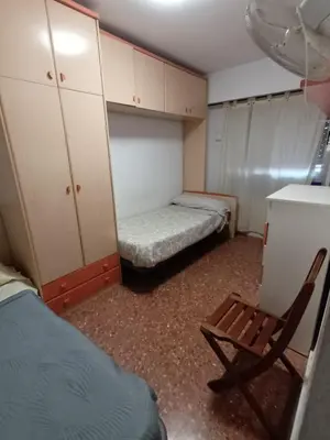 a small room with a bed and a chair in it at Habitación doble 45eur in Valencia